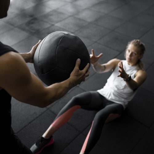 close-up-people-training-with-ball